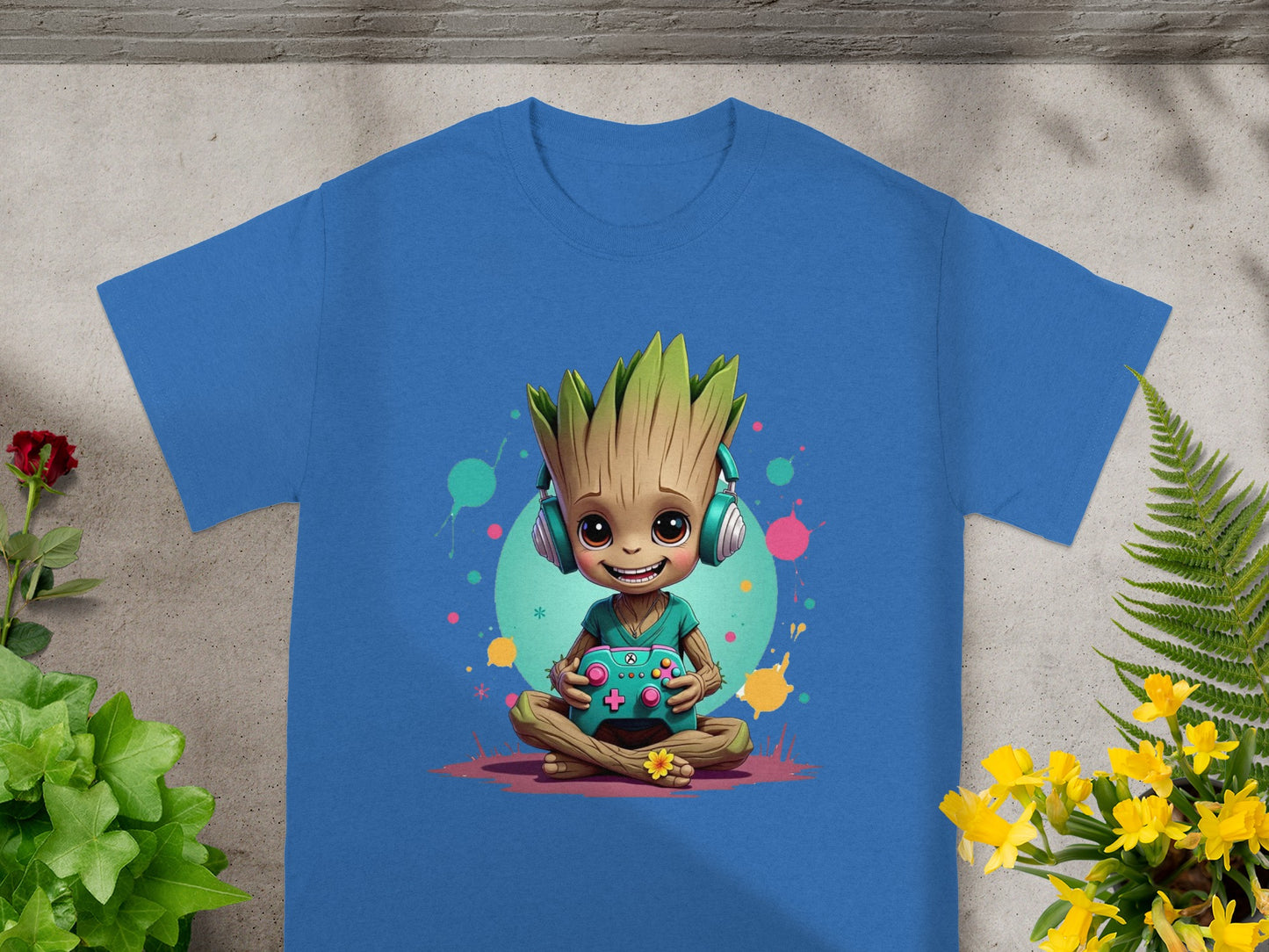 Groot wearing headphones and holding a game controller, sitting cross-legged.