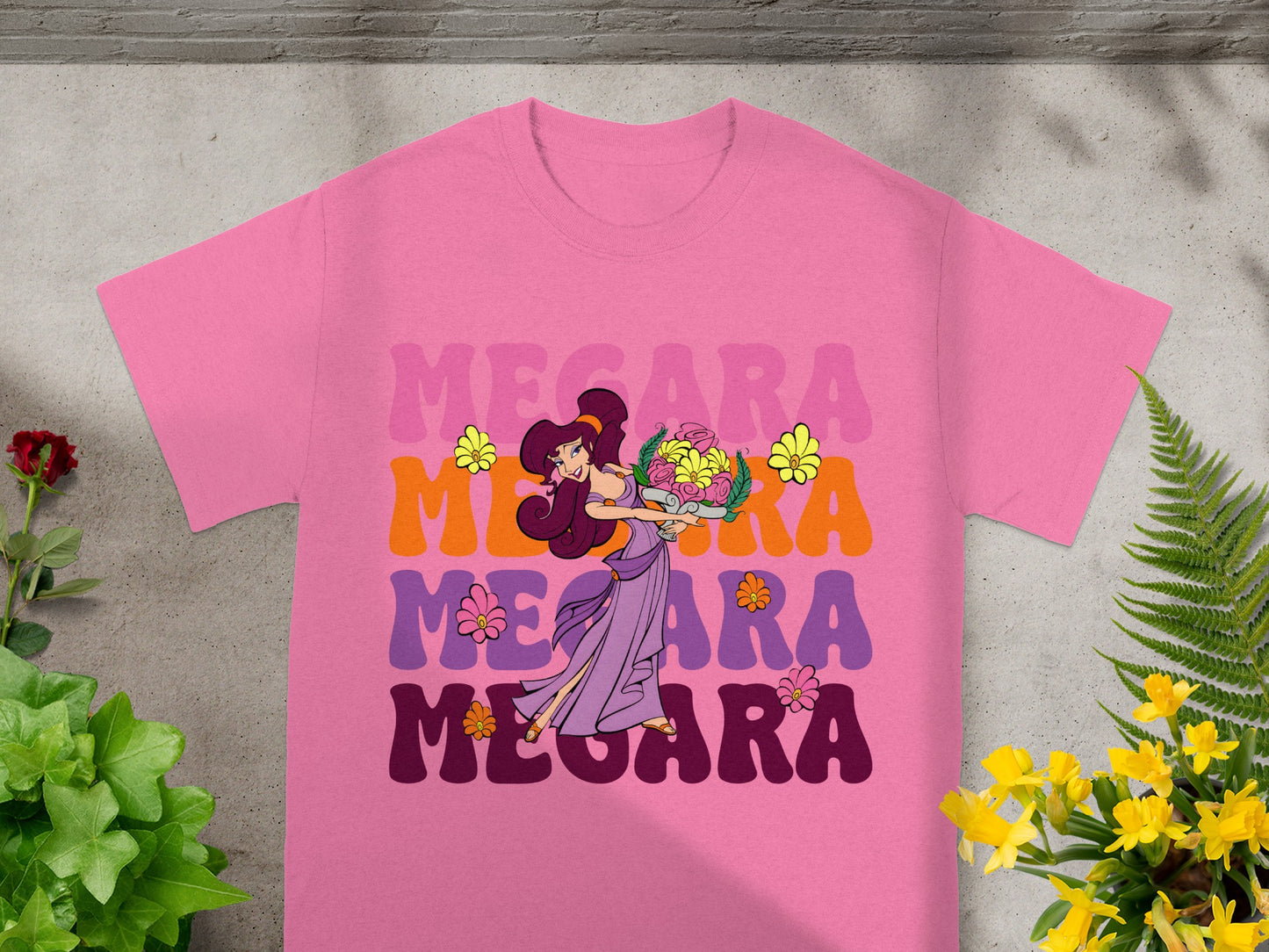 Megara graphic on a pink t-shirt with colorful text.