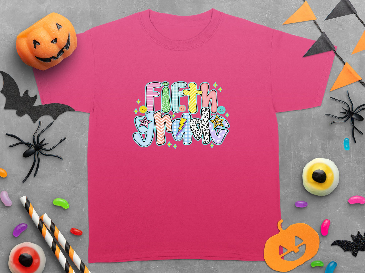 Pink t-shirt with "Fifth Grade" in colorful, patterned lettering.