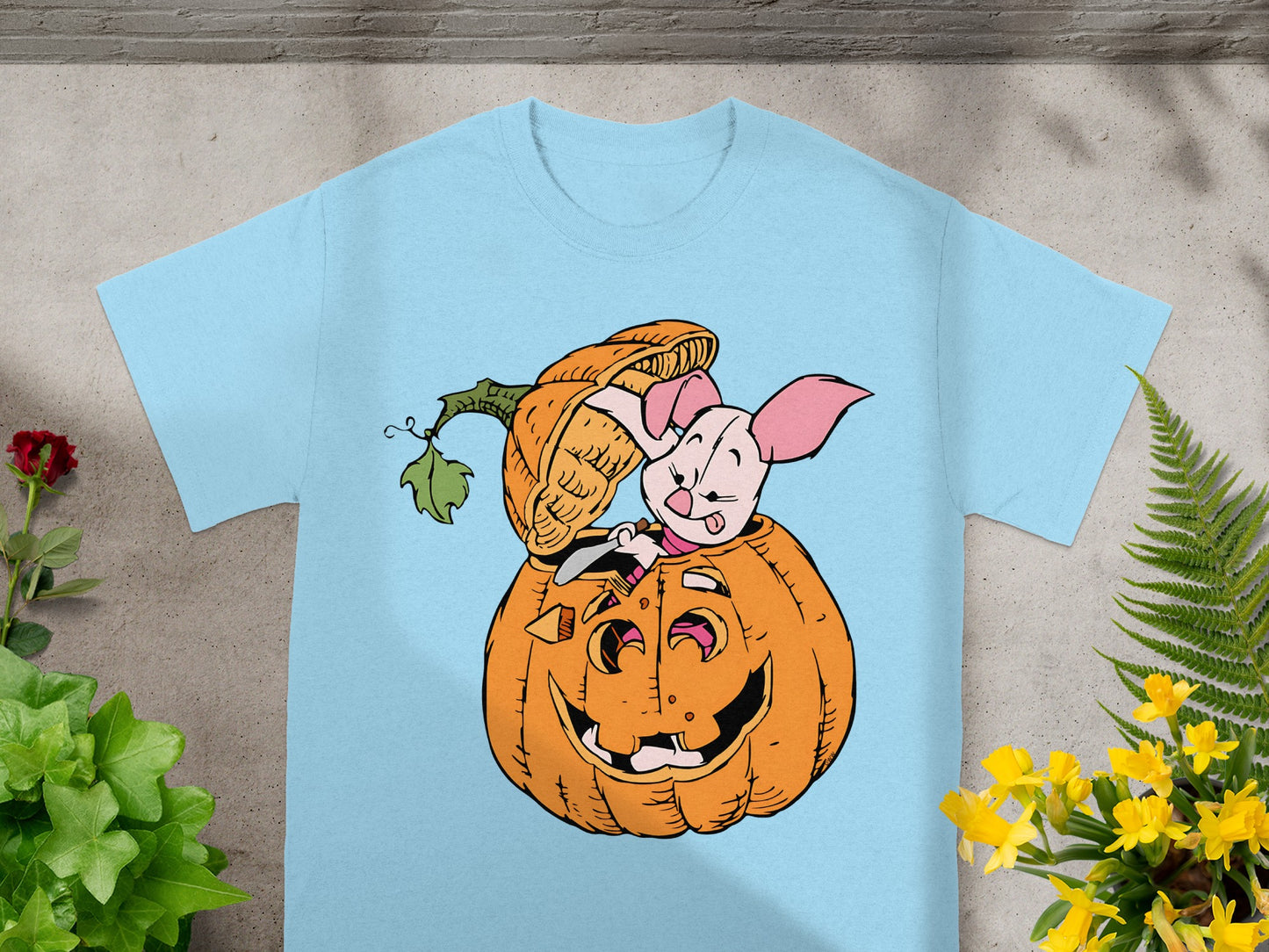 Light blue t-shirt with Piglet peeking out of a jack-o'-lantern.