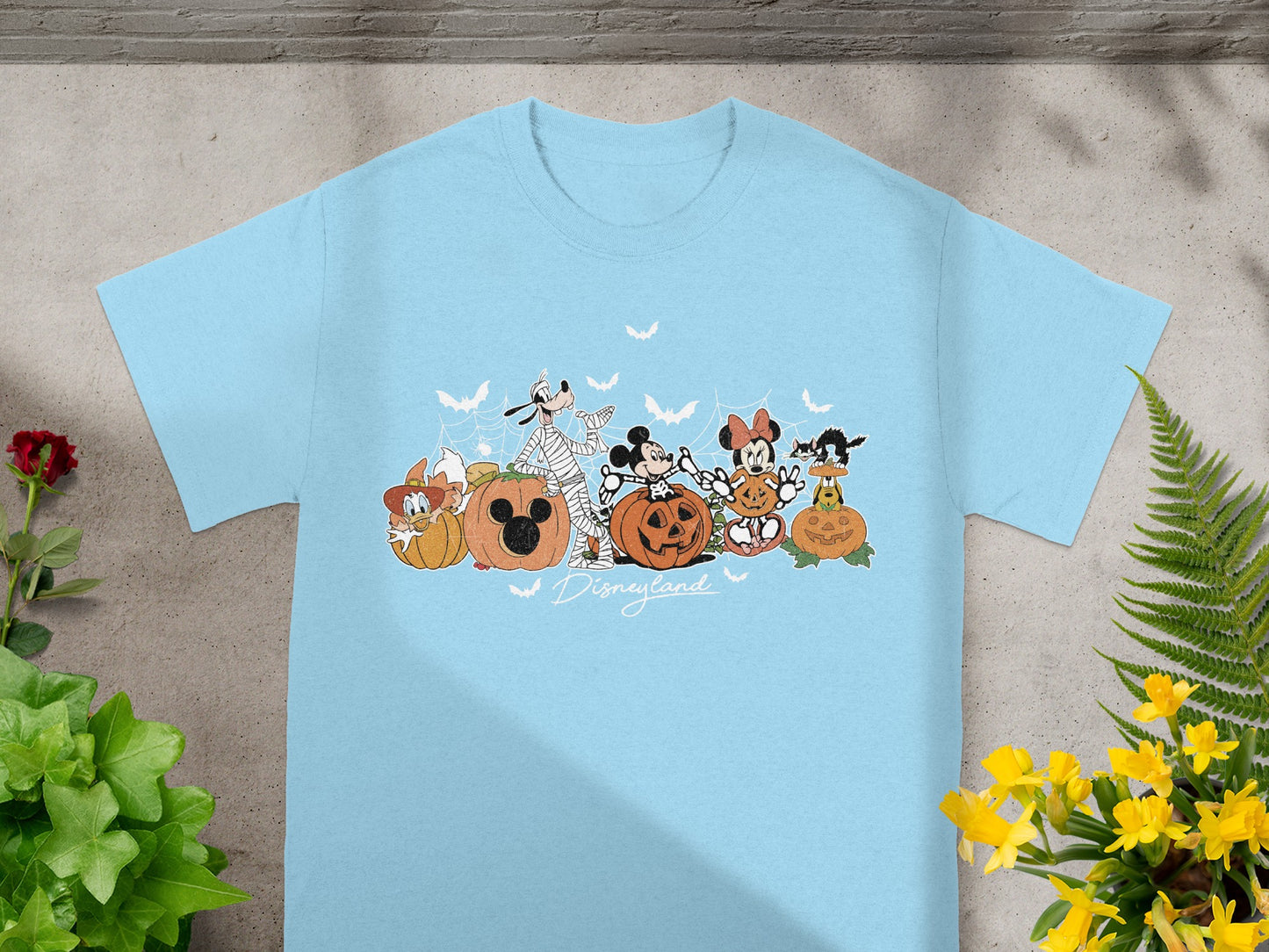 Light blue t-shirt with Halloween Disney characters and Disneyland text graphic.