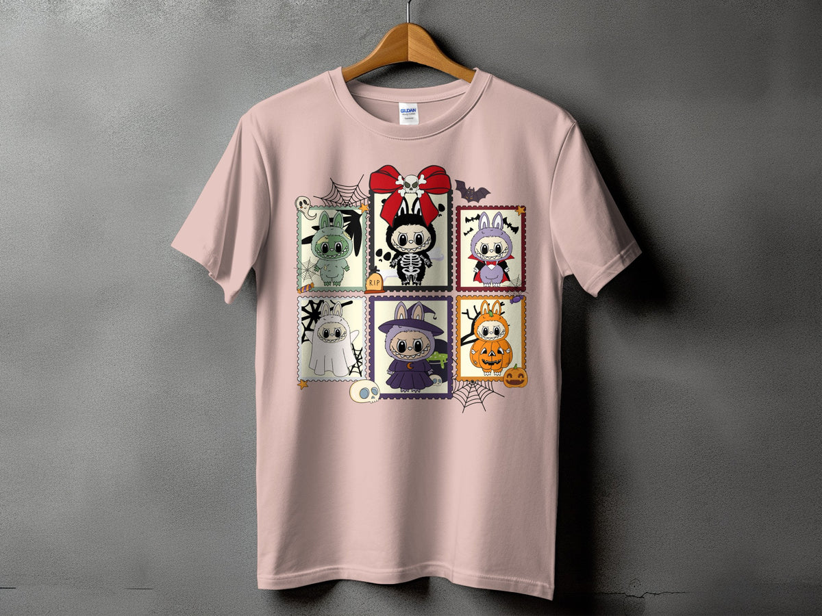 Pink t-shirt with six Halloween-themed cartoon postage stamps featuring bunnies and pumpkins.
