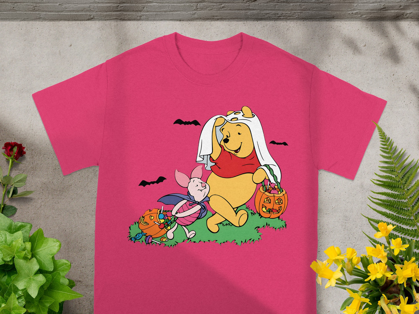 Winnie the Pooh and Piglet in Halloween costumes carrying candy buckets.