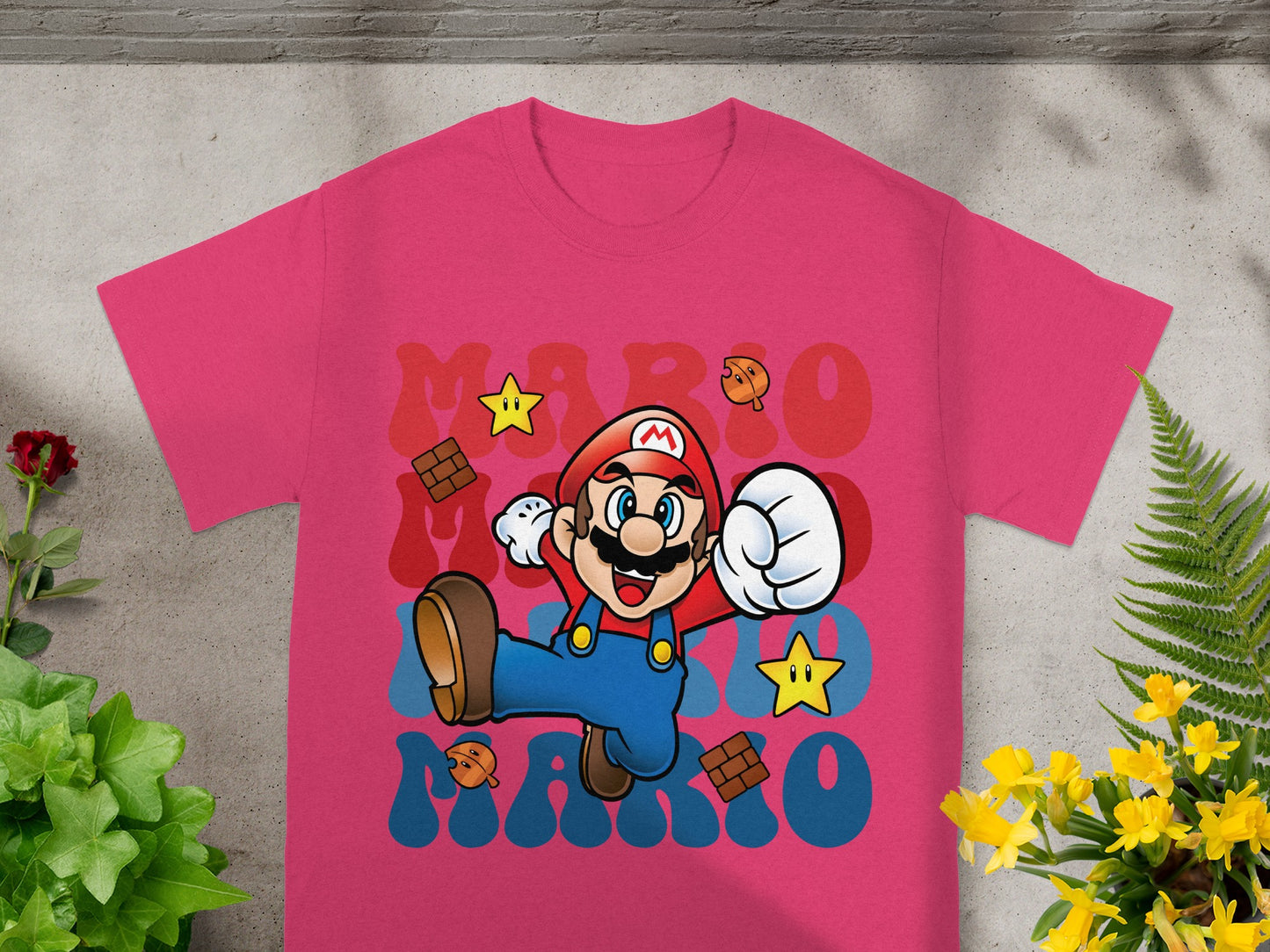 Pink t-shirt with Mario, stars, and "MARIO" text in retro font.