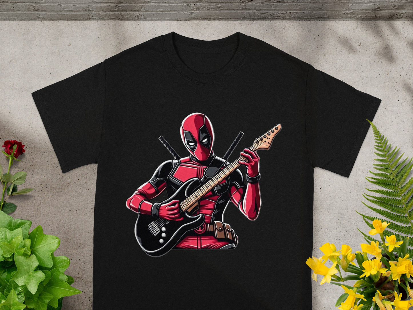 Black t-shirt with Deadpool playing an electric guitar.