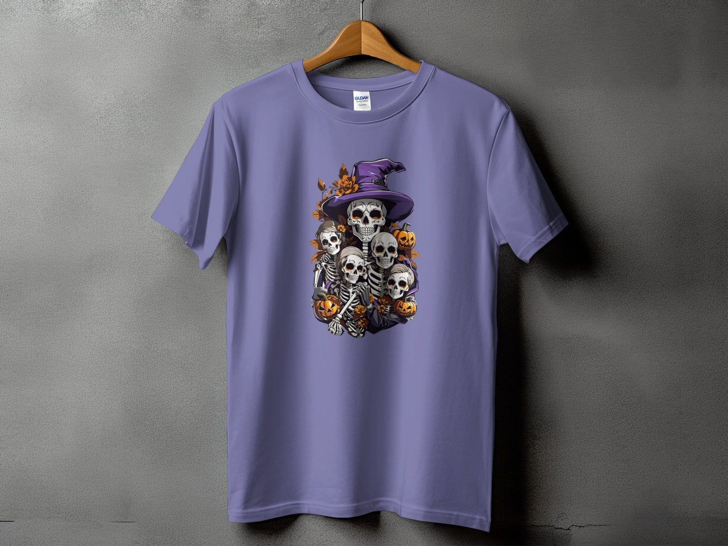 Purple t-shirt with a Halloween graphic featuring skeletons, witch hat, and pumpkins.