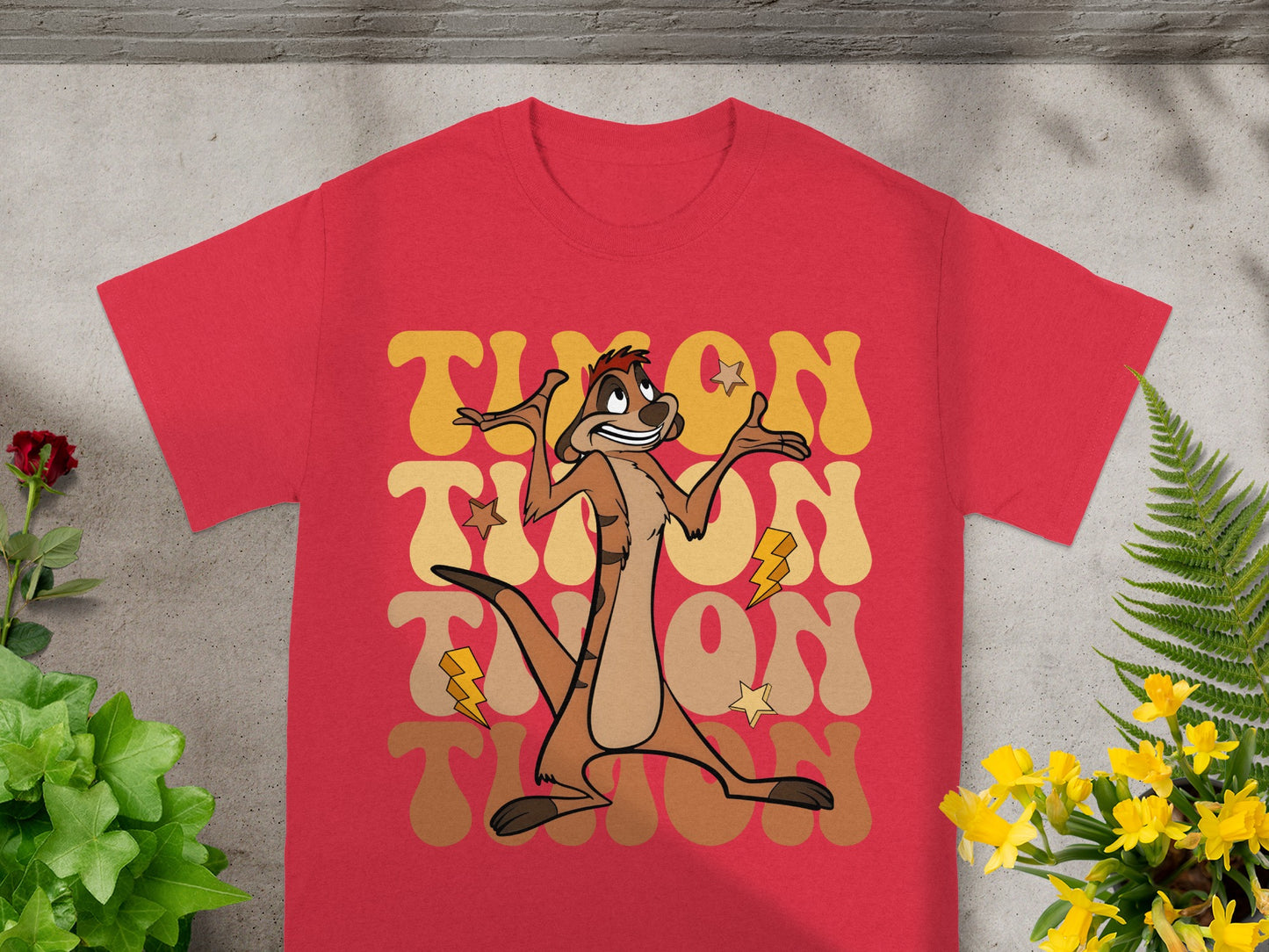 Red t-shirt with "Timon" text and lightning bolts, featuring a character.