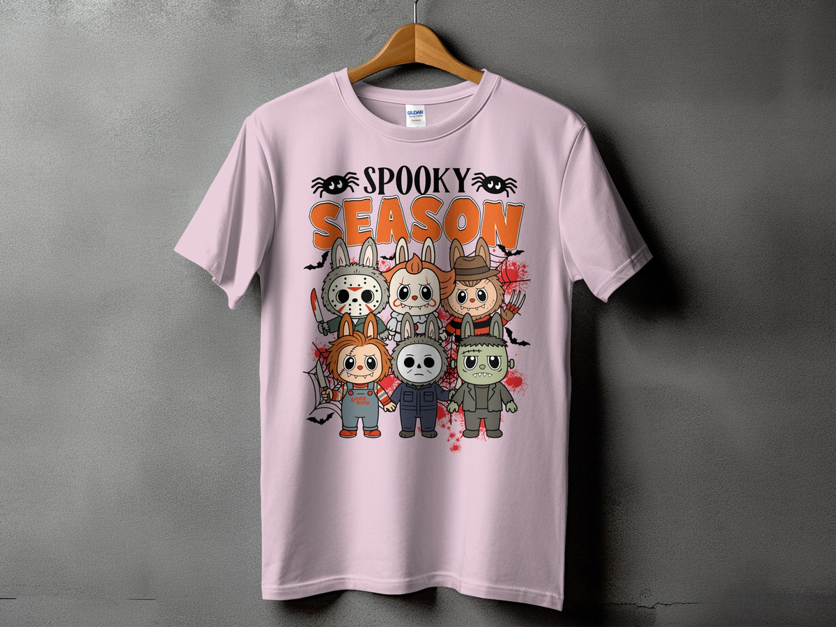 Pink t-shirt with "Spooky Season" and horror movie characters in a cartoon style.
