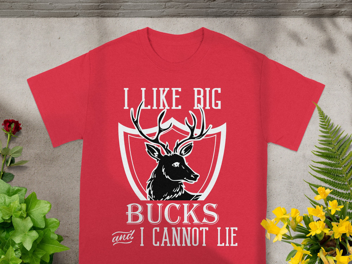 Red t-shirt with deer graphic and text "I LIKE BIG BUCKS and I CANNOT LIE".