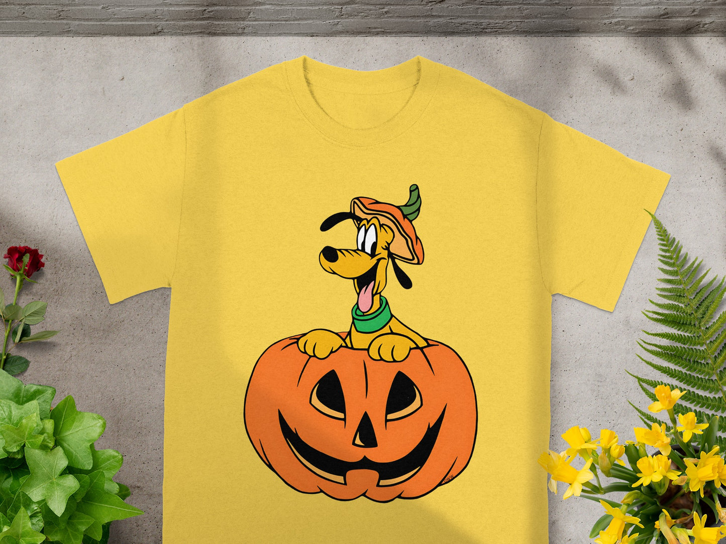 Yellow t-shirt with a cartoon Pluto emerging from a jack-o'-lantern.