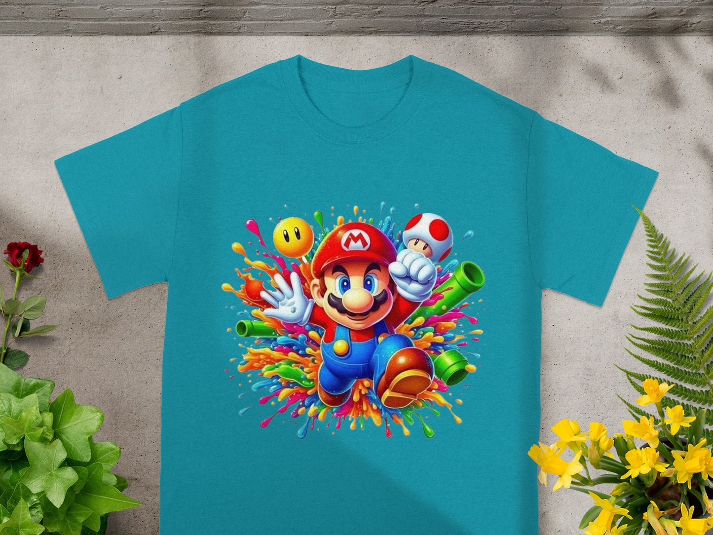 Teal t-shirt with Mario in colorful paint splatters and game elements.