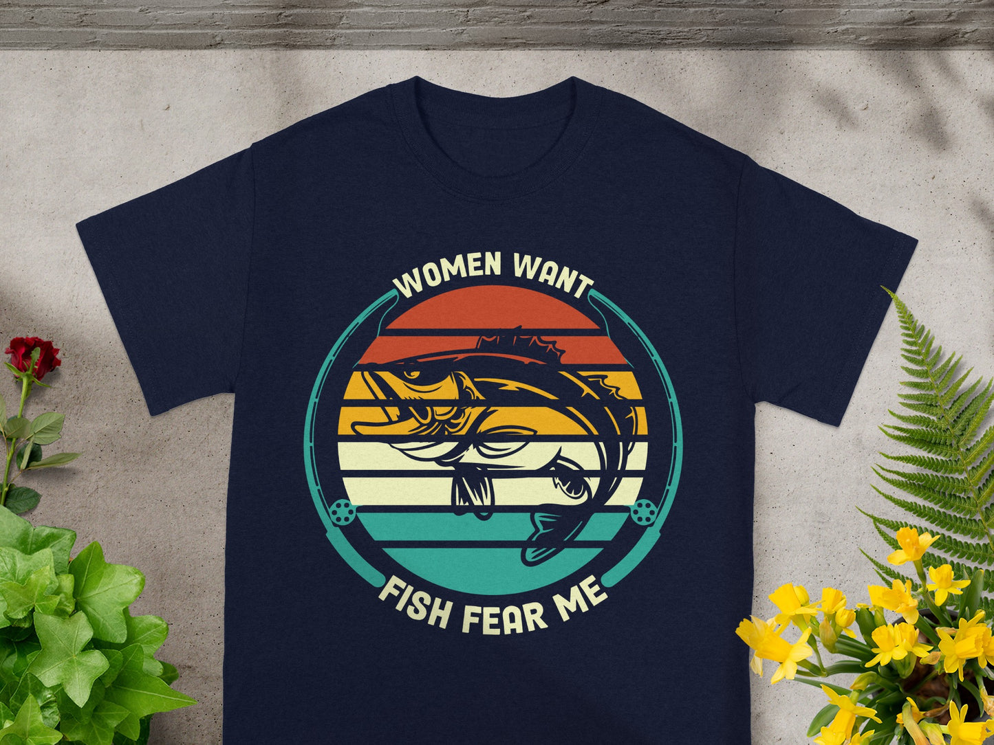Navy t-shirt with sunset graphic of a fish saying "Women want, fish fear me".