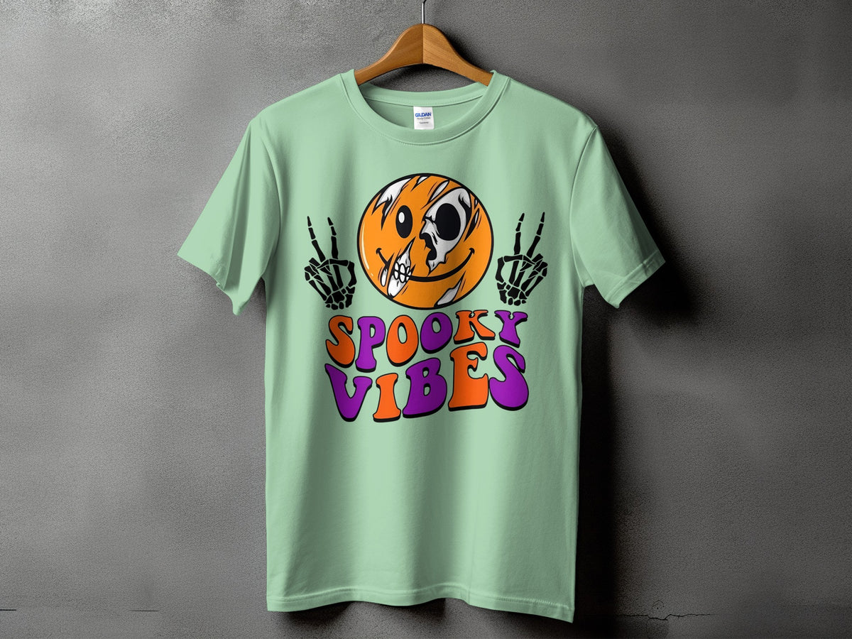 Light green t-shirt with a skull-faced smiley and "Spooky Vibes" text.