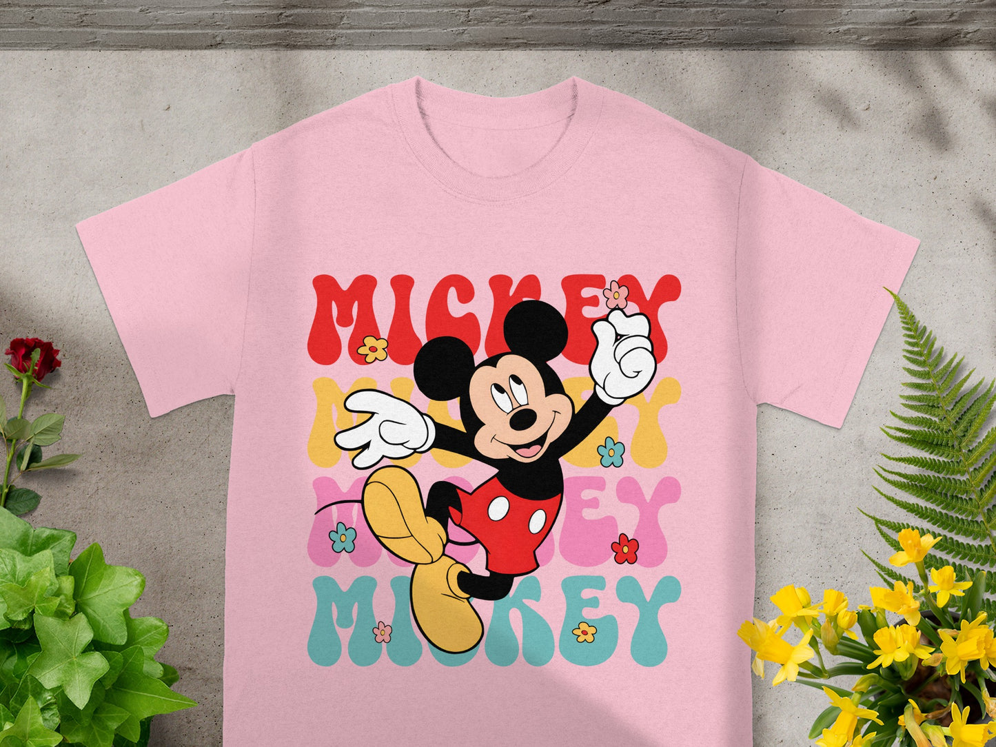Pink t-shirt with Mickey Mouse graphic and "Mickey" text in colorful bubble letters.