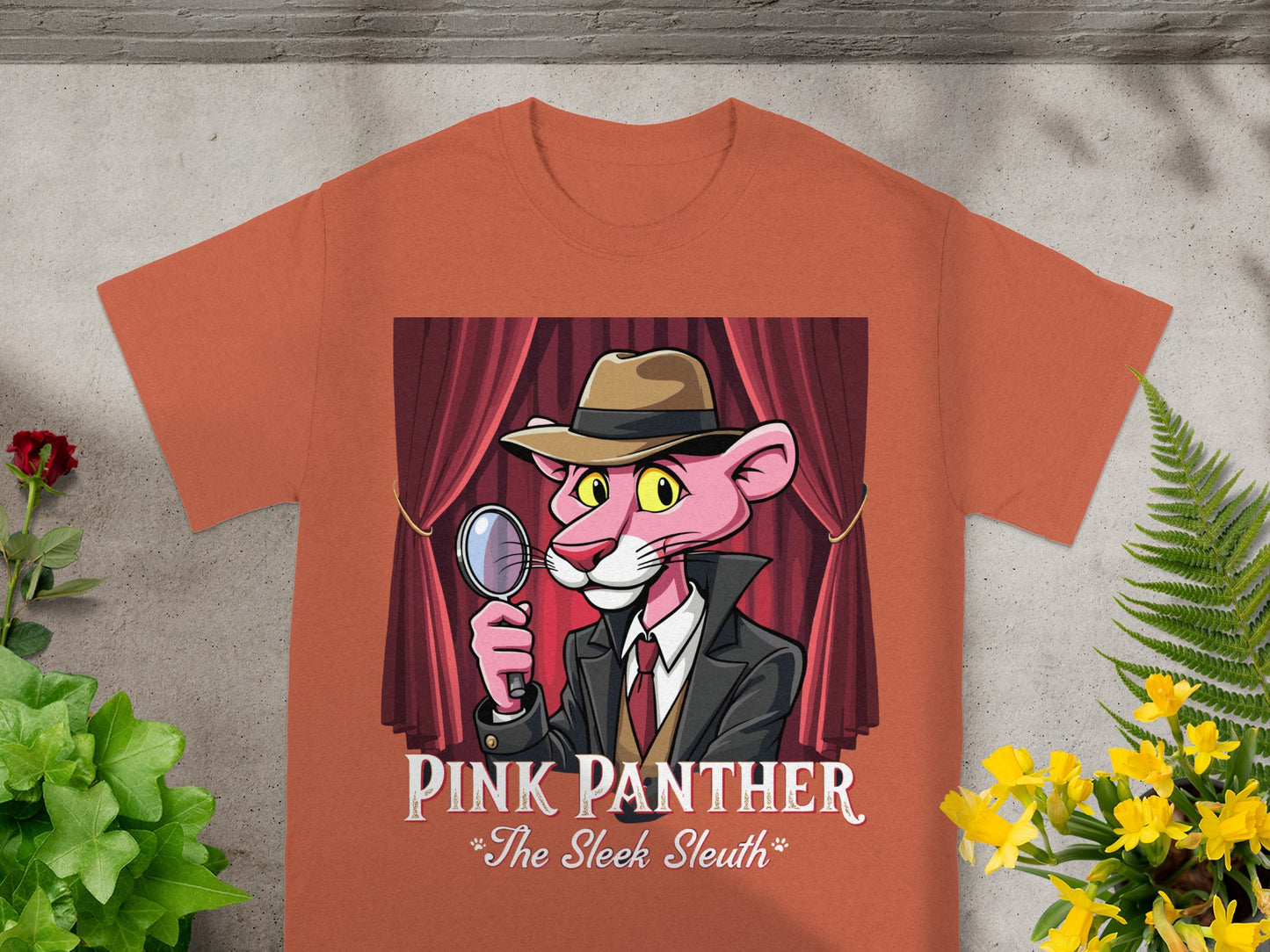 Pink Panther graphic with text "Pink Panther The Sleek Sleuth" on orange t-shirt.