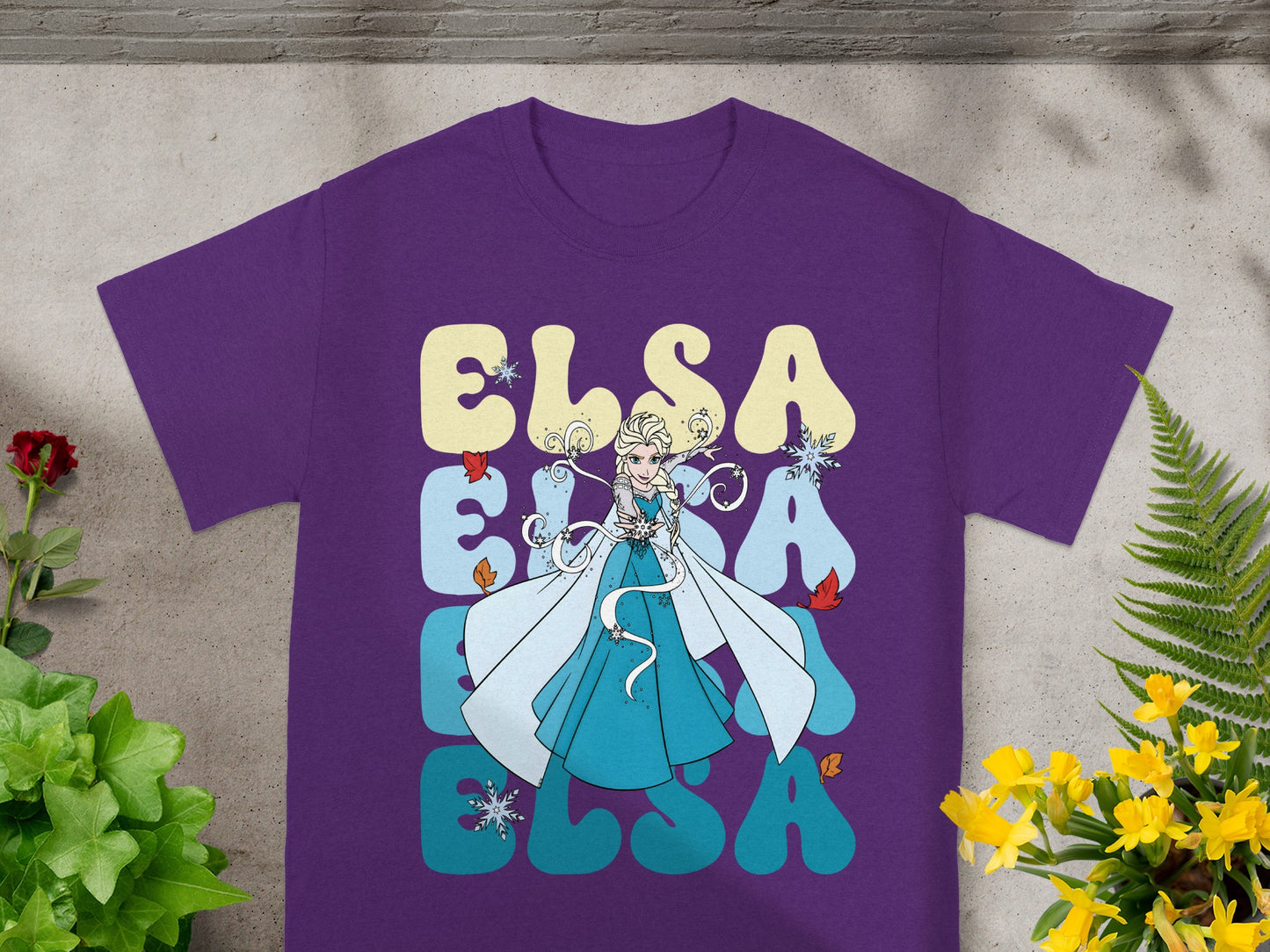 Purple t-shirt with Elsa graphics and "ELSA" text in groovy font.
