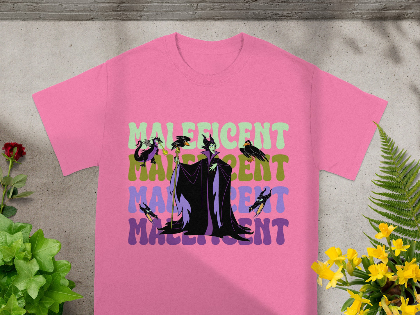 Pink t-shirt with Maleficent graphic and text.
