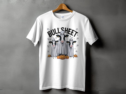White t-shirt with three cows dressed as ghosts and wearing witch hats.