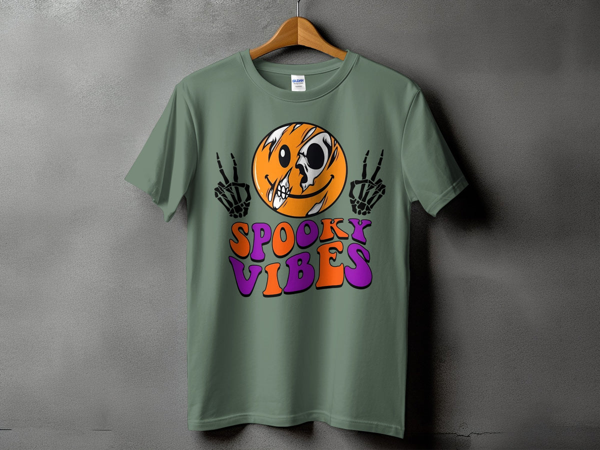 Green t-shirt with skeleton hands, skull face, and "Spooky Vibes" text.