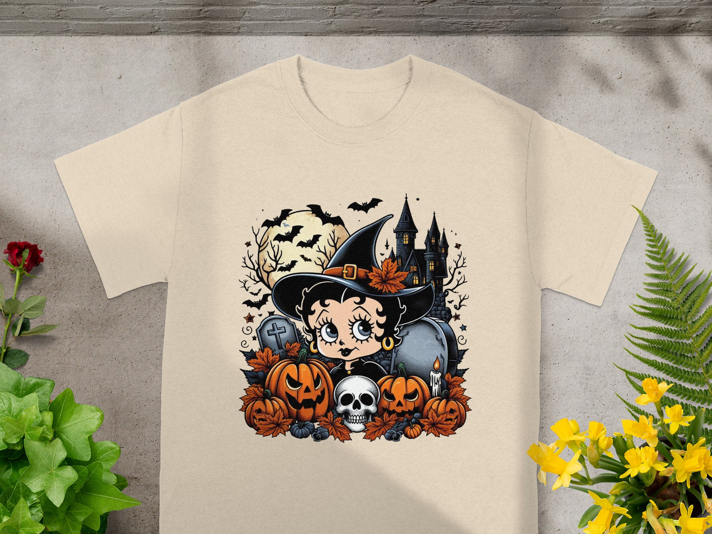 Betty Boop as a witch with pumpkins, skull, and haunted castle.