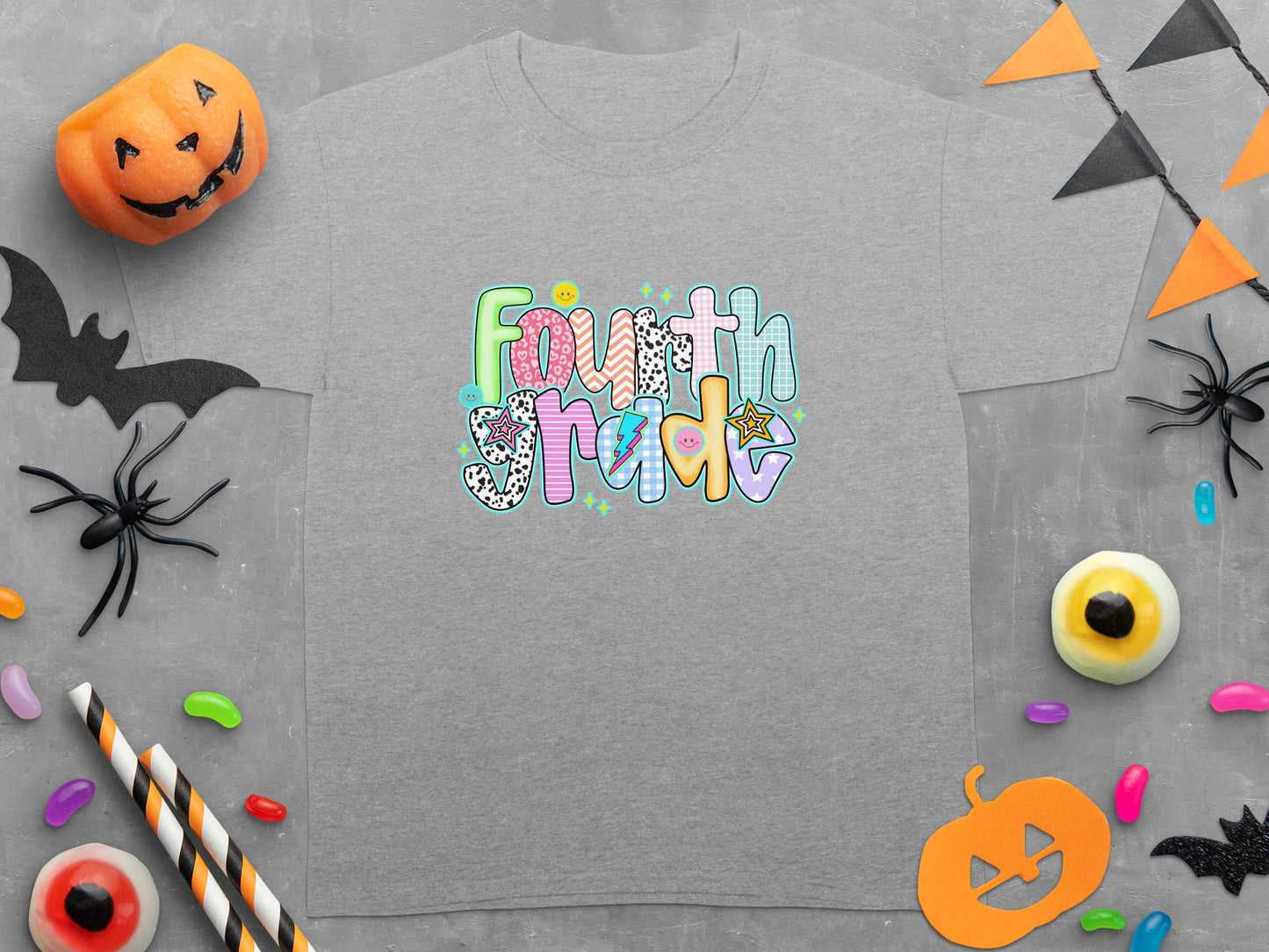 Grey t-shirt with colorful "Fourth Grade" text and Halloween decorations.