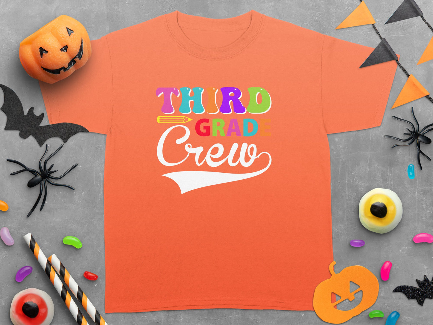 Orange t-shirt with colorful "Third Grade Crew" text and Halloween decorations.
