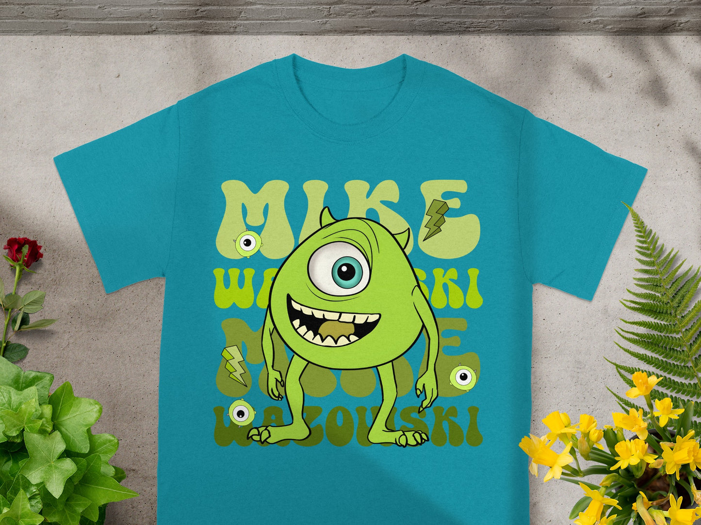 Teal t-shirt with green cartoon monster and "MIKE WAZOWSKI" text.