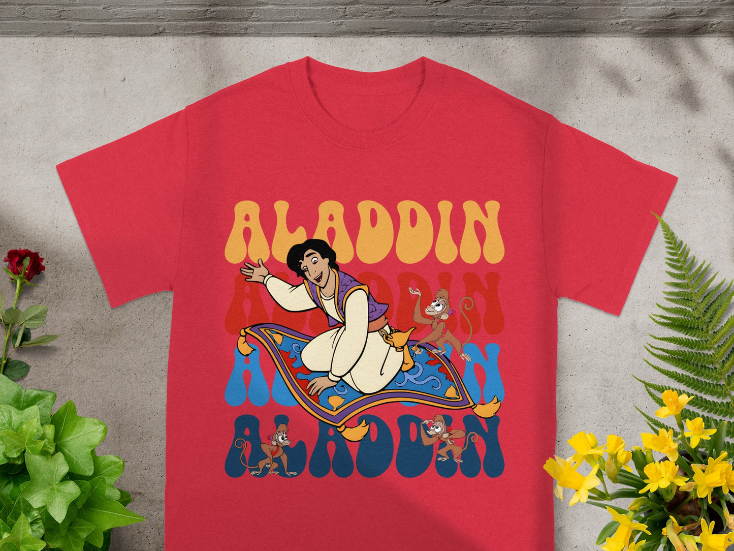 Aladdin character on flying carpet with monkeys, retro text "Aladdin".
