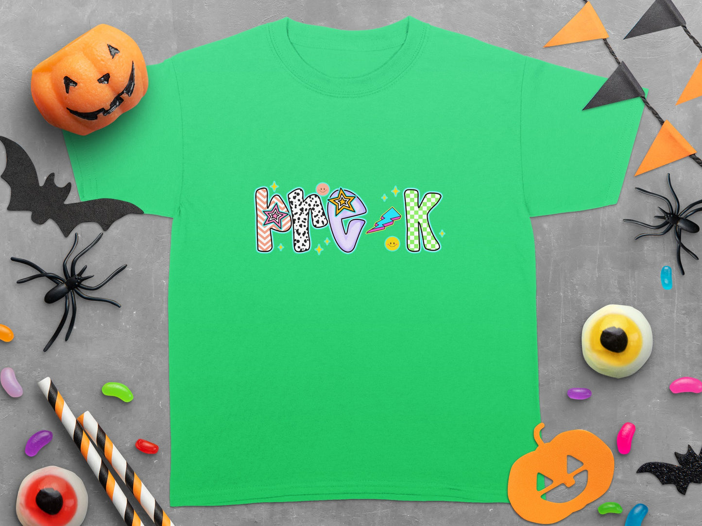 Green t-shirt with "Pre-K" text in colorful Halloween-themed letters.