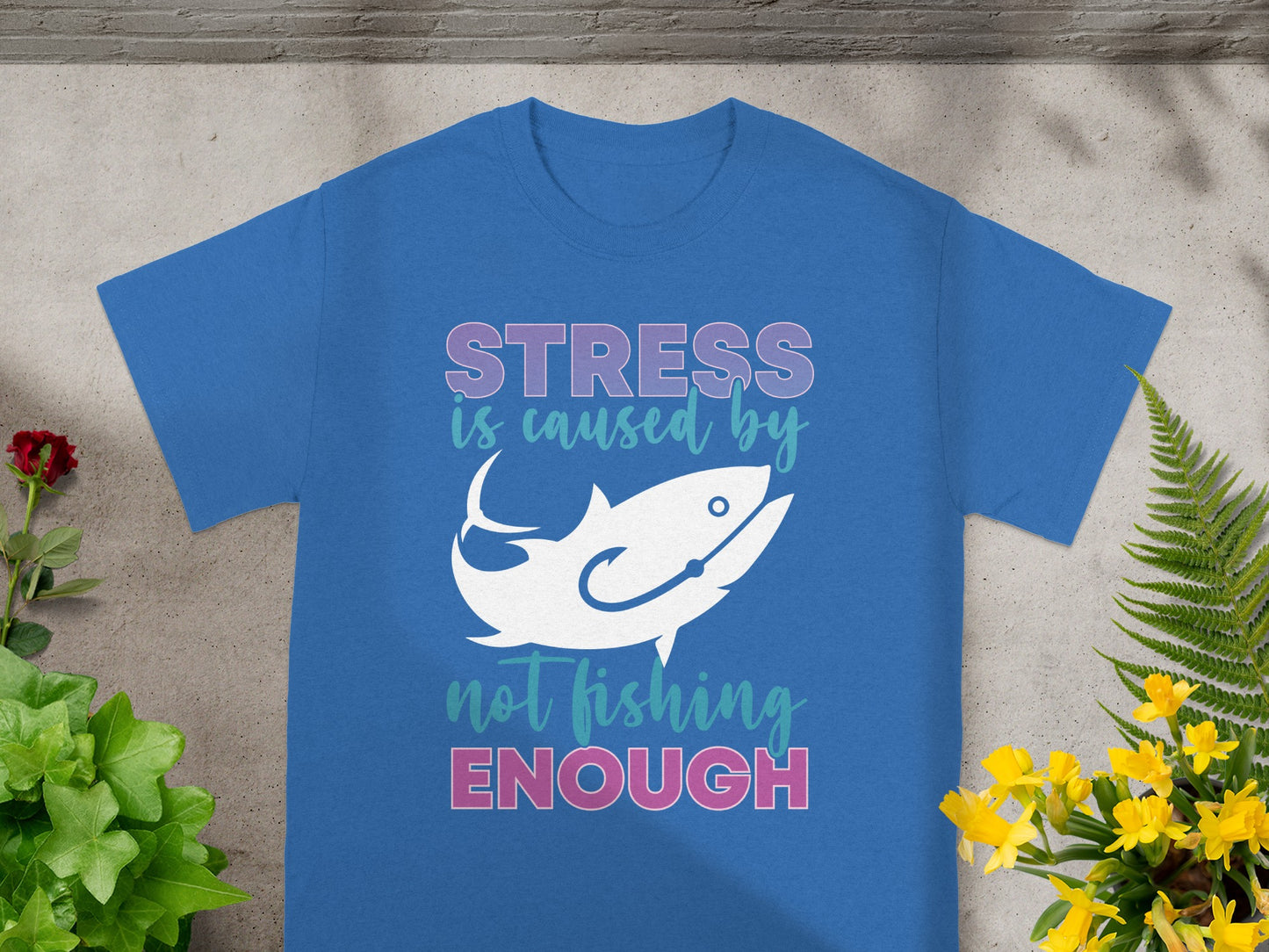 Blue t-shirt with "Stress is caused by not fishing enough" and a fish graphic.
