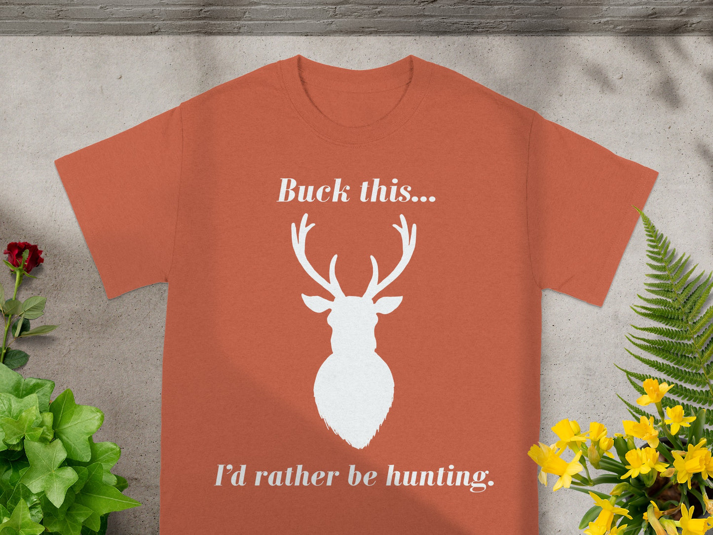 Orange t-shirt with white text "Buck this..." above a deer silhouette and "I'd rather be hunting."