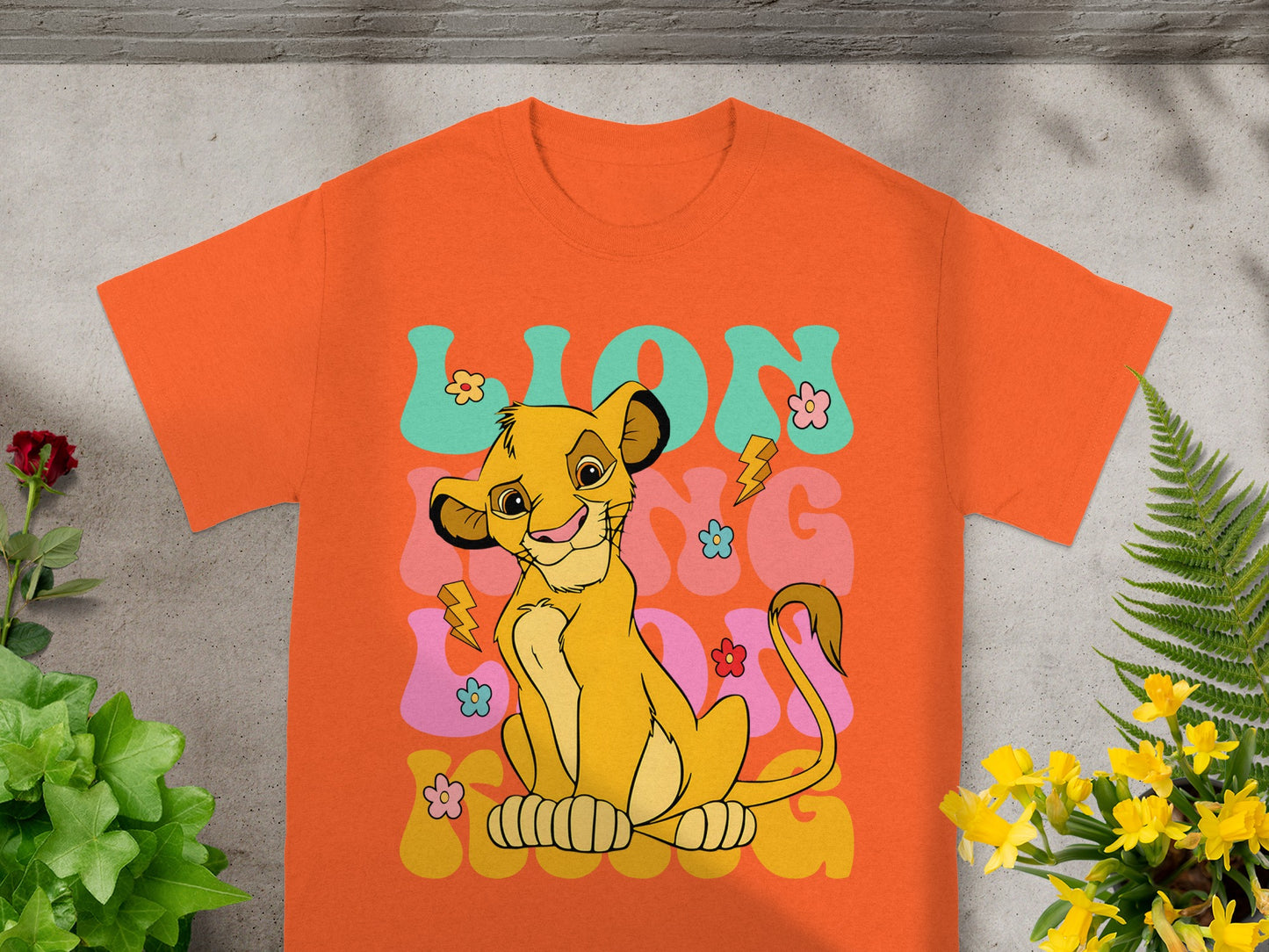 Orange t-shirt with Simba from The Lion King and "LION" text.
