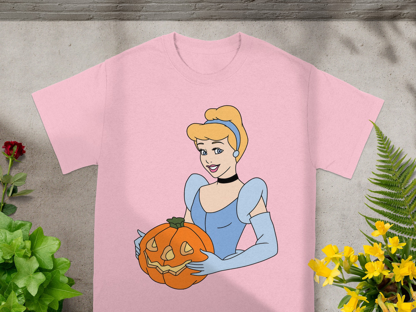 Pink t-shirt with Cinderella holding a jack-o'-lantern.
