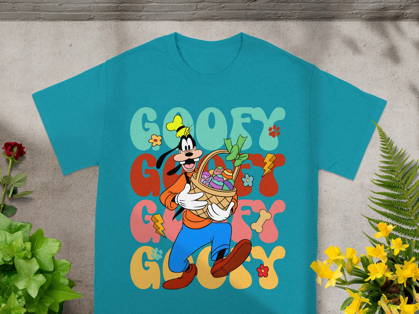 Goofy in a t-shirt holding an Easter basket with colorful eggs.