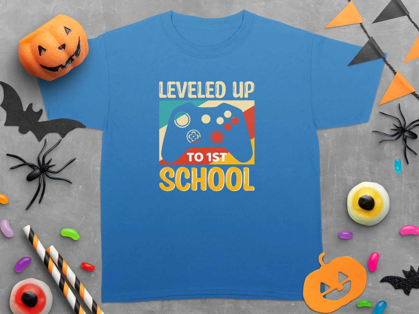 Blue t-shirt with text "Leveled Up to 1st School" and video game controller graphic.