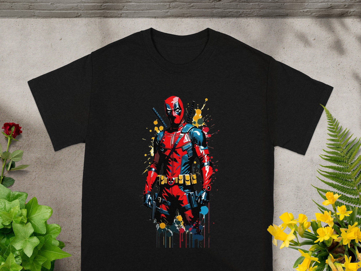 Black t-shirt featuring a colorful, action-ready Deadpool character illustration.