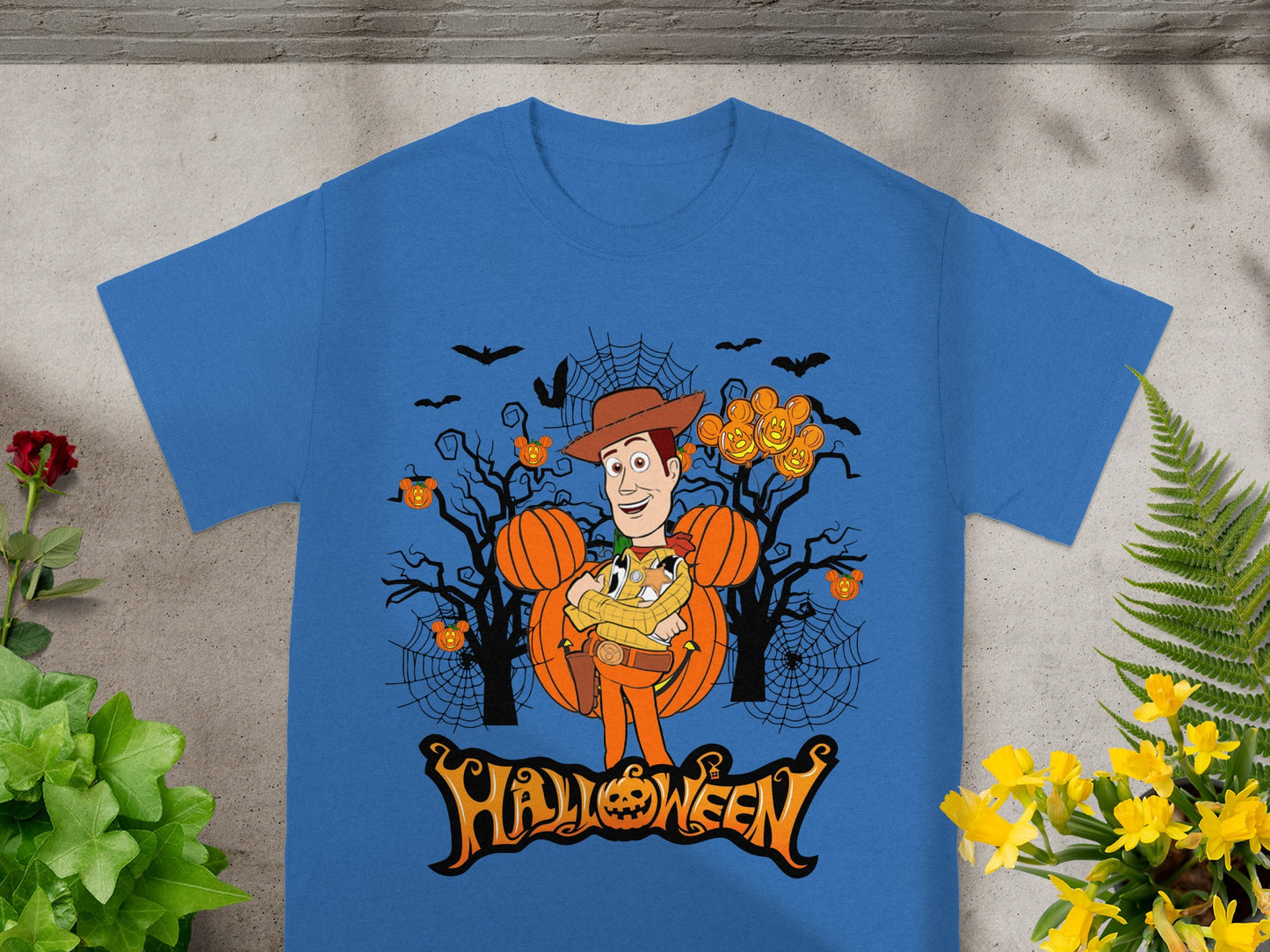 Woody character with Mickey Mouse pumpkin ears and Halloween trees graphic.