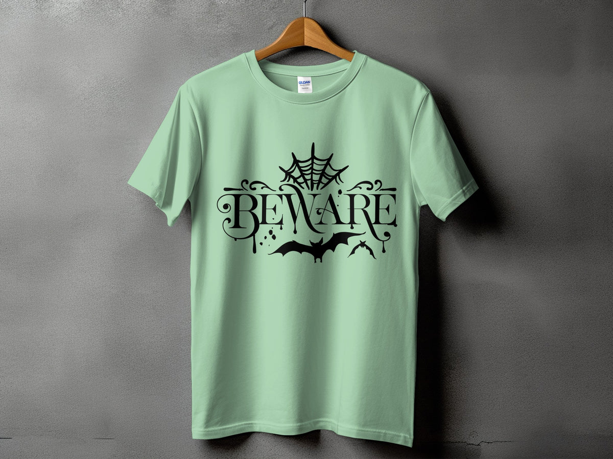 Light green t-shirt with "BEWARE" text, spiderweb, and bats graphic.