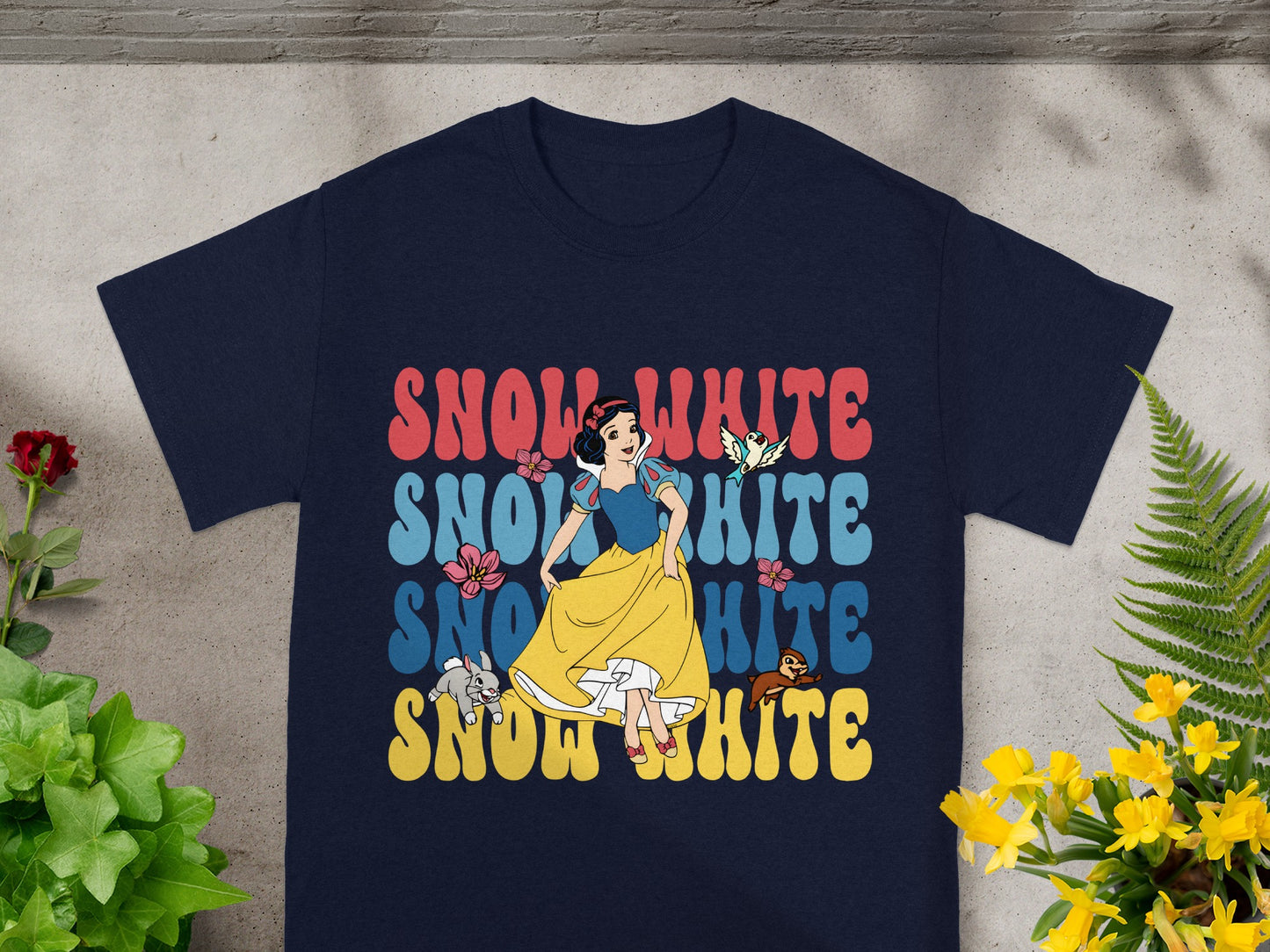 Snow White graphic on a navy blue t-shirt with yellow accents.