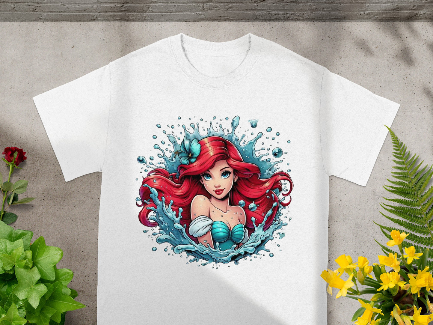 White t-shirt featuring Ariel from The Little Mermaid with water splashes.