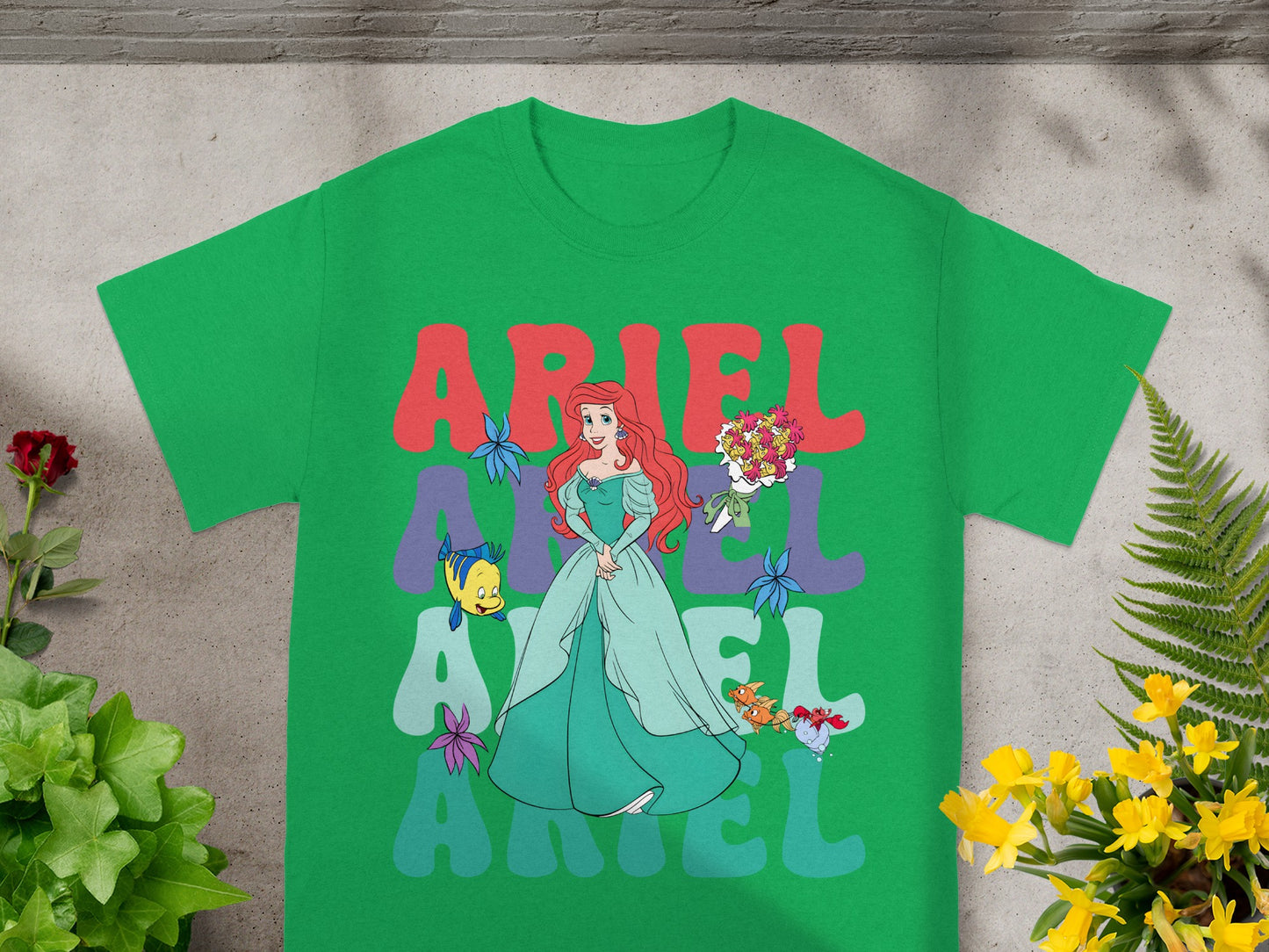 Green t-shirt with Ariel and "ARIEL" text in colorful letters.