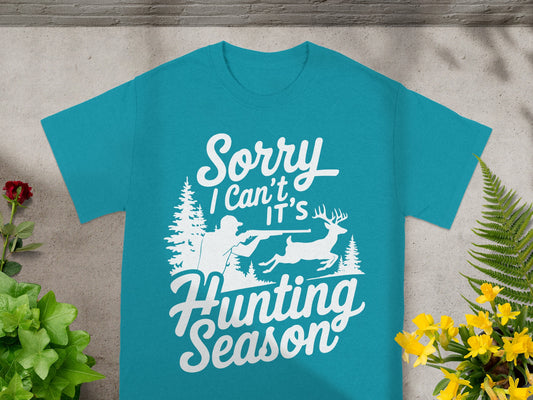 Teal t-shirt with white text and graphic of hunter and deer.