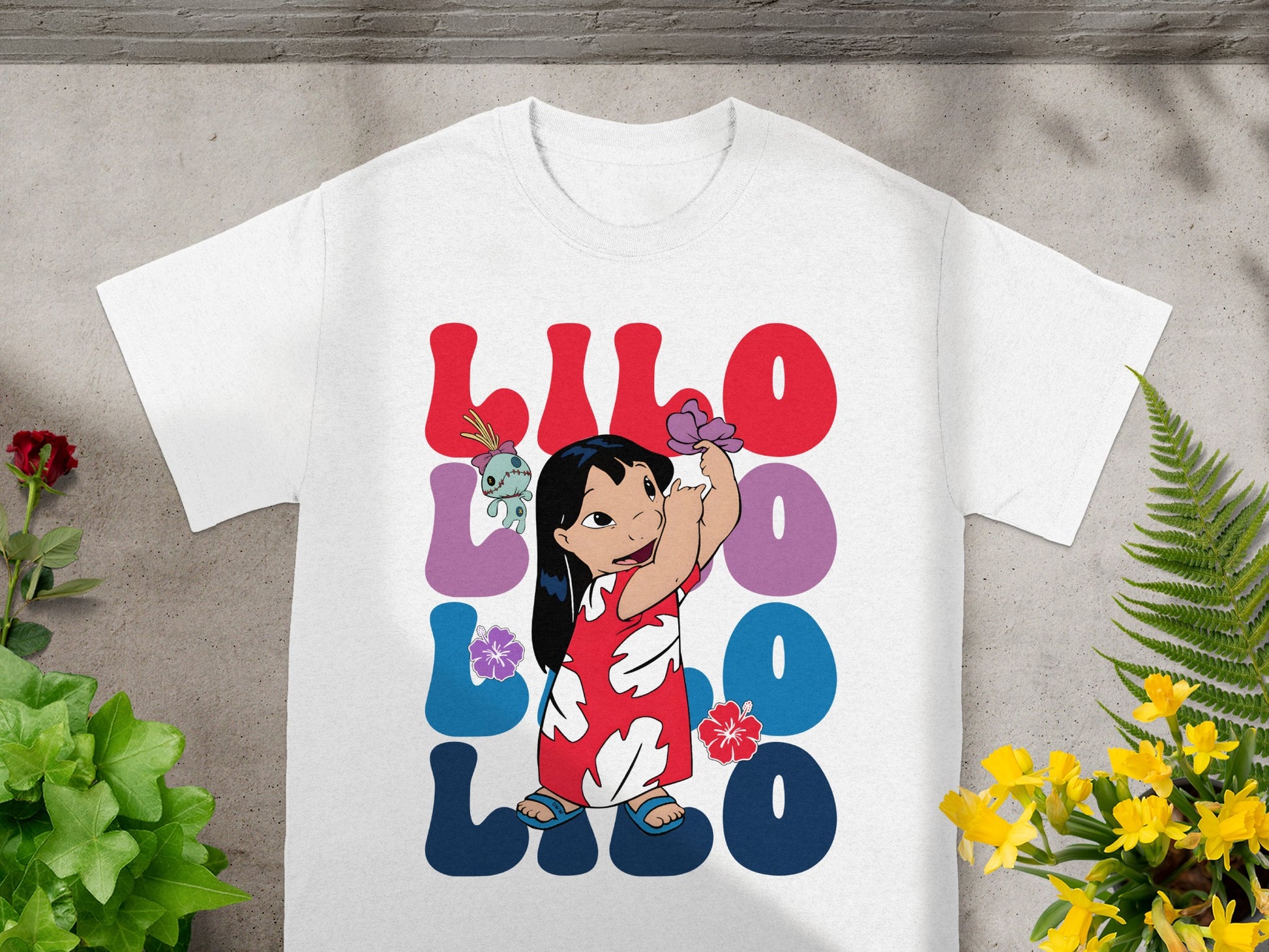 White t-shirt featuring Lilo & Stitch graphic with bold "Lilo" text.