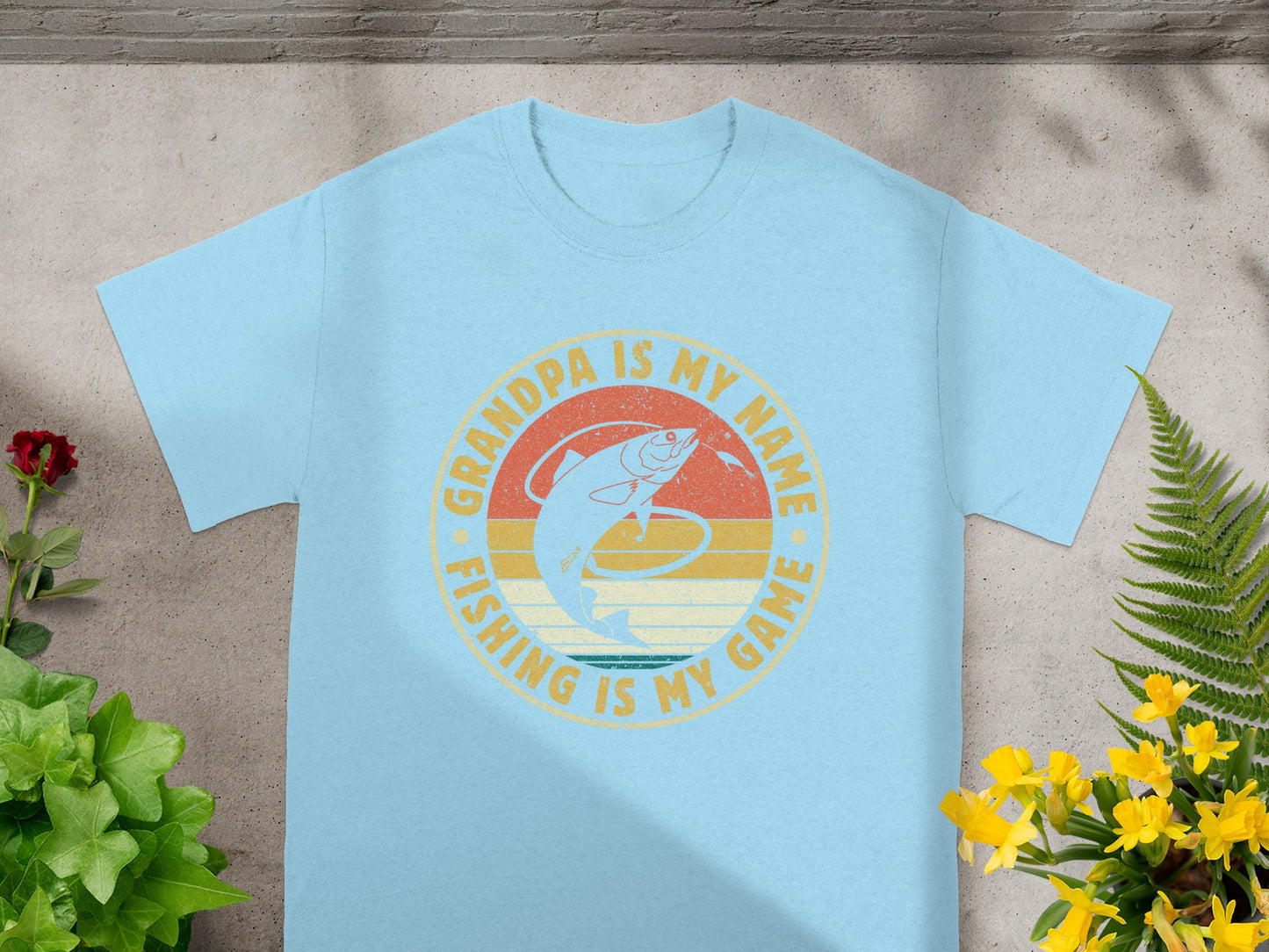 Light blue t-shirt with "Grandpa is my name fishing is my game" text and a fish graphic.