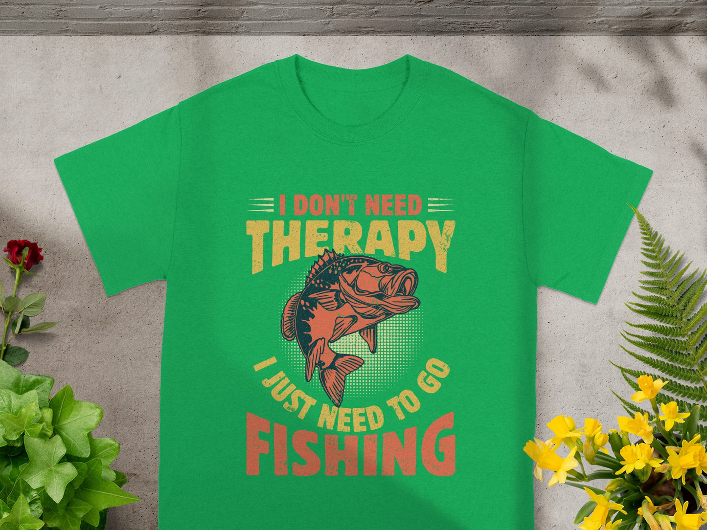 Green t-shirt with text "I DON'T NEED THERAPY I JUST NEED TO GO FISHING" and a fish graphic.