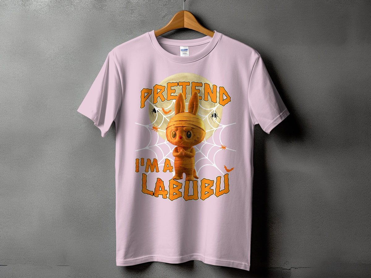 Pink t-shirt with Halloween graphic of mummy Labubu character and text "PRETEND I'M A LABUBU".