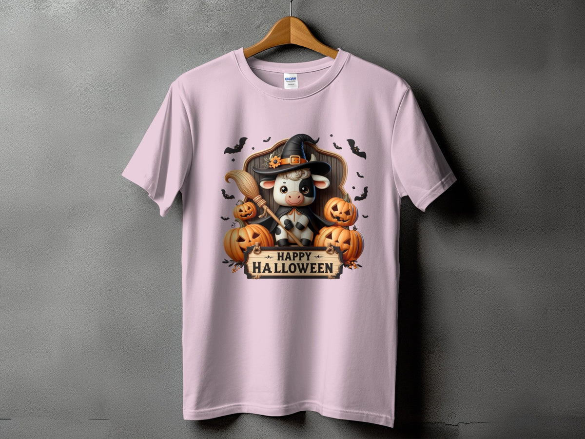 Pink t-shirt with a cow in a witch hat holding a broom and pumpkins, with "Happy Halloween" text.