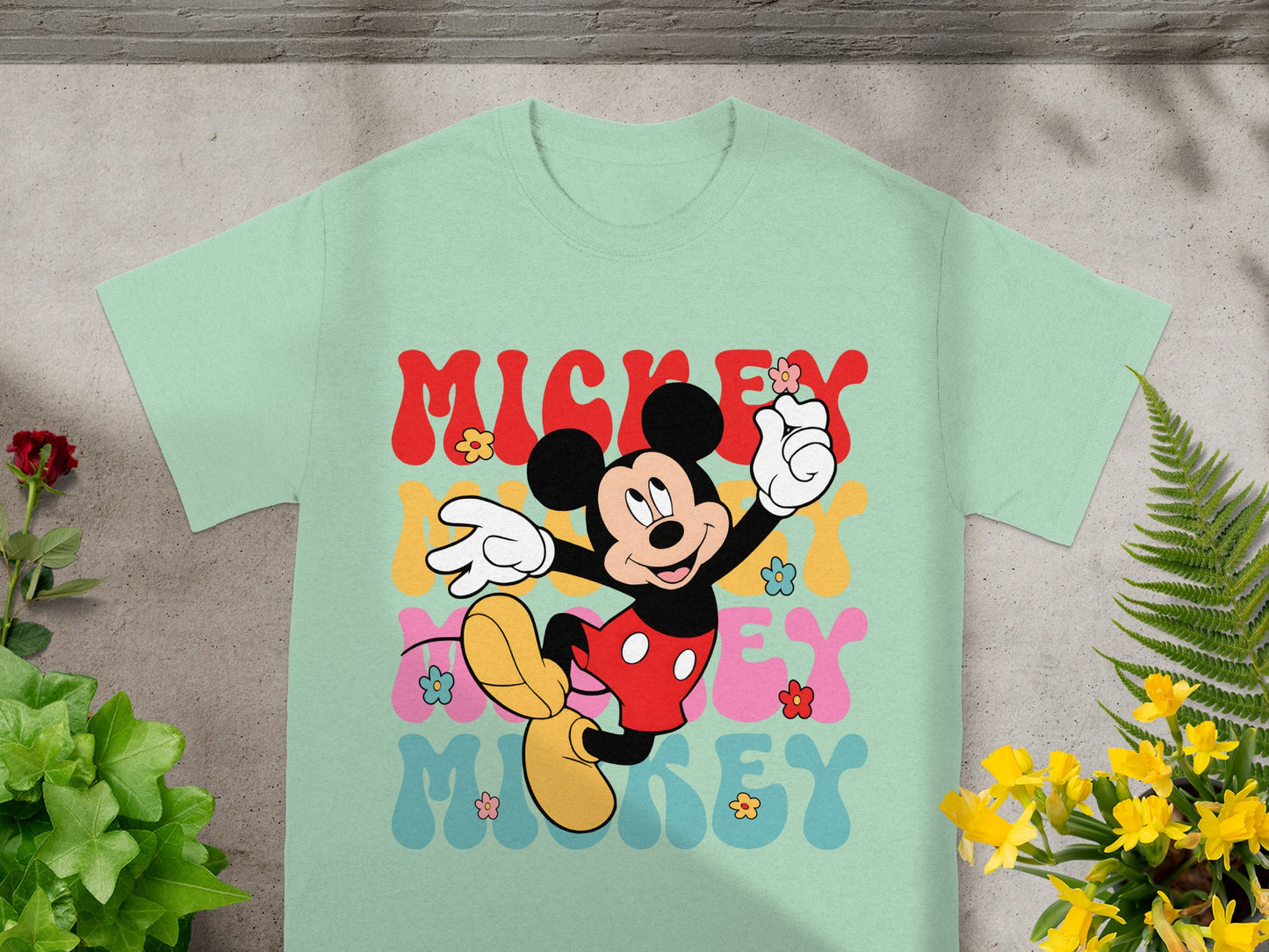 Mint t-shirt with retro Mickey Mouse graphic and colorful flowers.