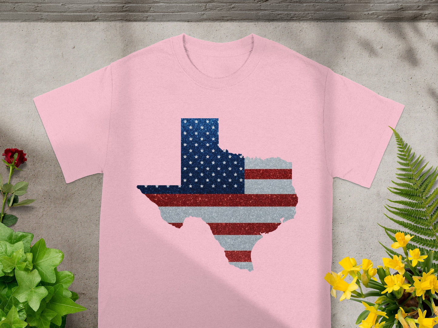 Pink t-shirt with Texas map outline filled with American flag glitter design.