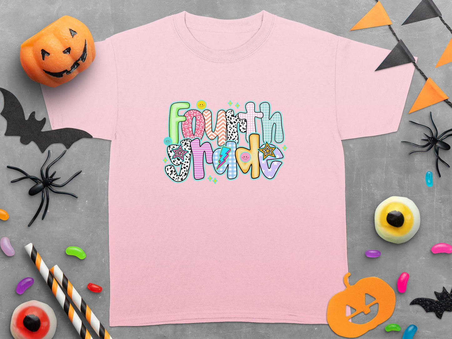 Pink t-shirt with "Fourth Grade" graphic and Halloween decorations.